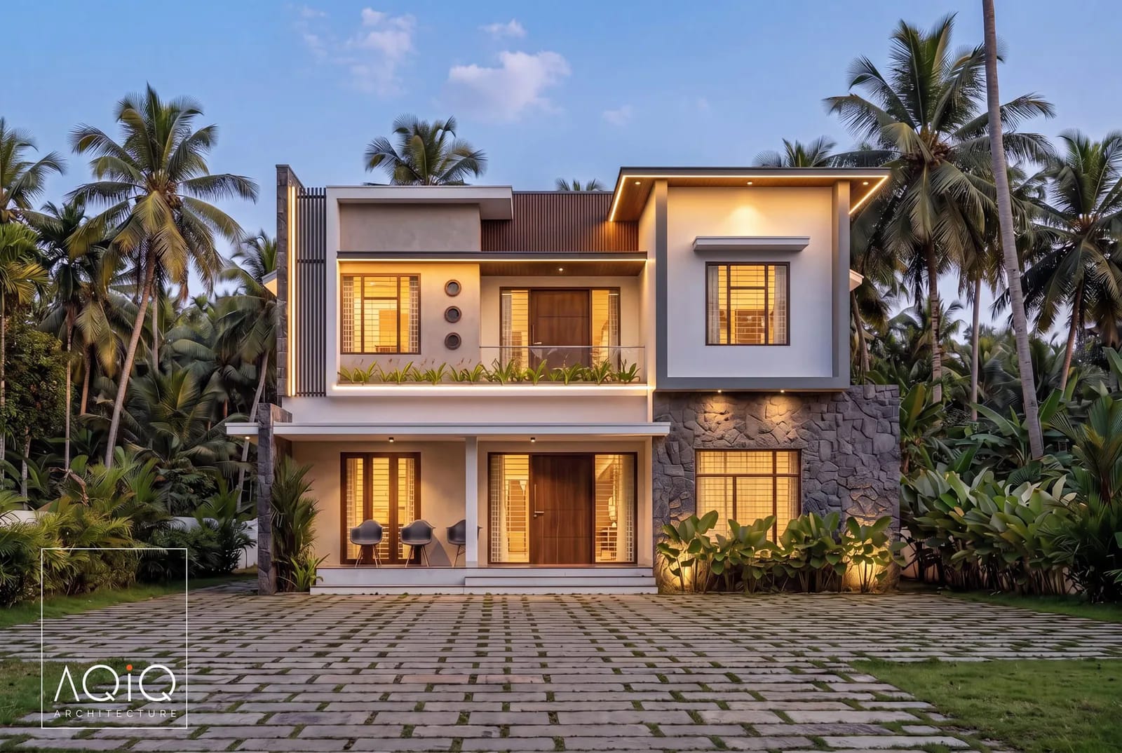 Two-storey villa at dusk with warm eaves lighting among palm trees