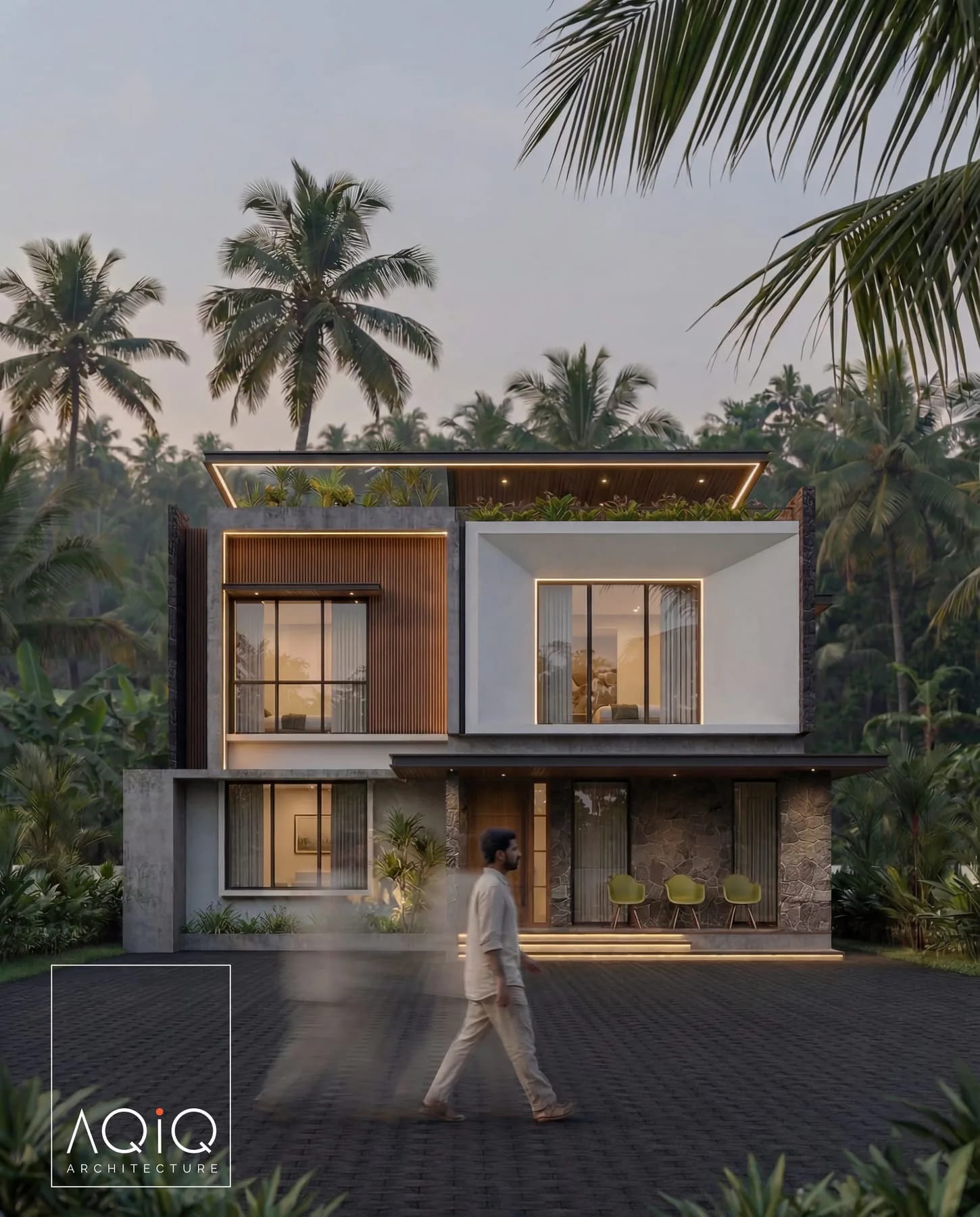 Dusk view of a villa with stone walls, timber screens, and palm trees